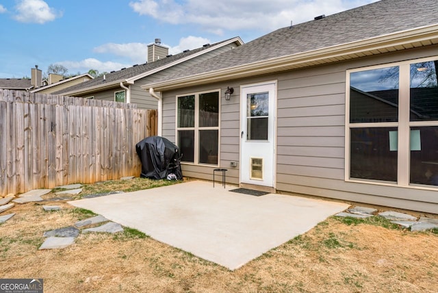 exterior space with a grill and fence