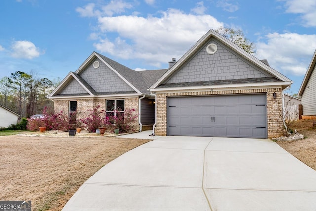 craftsman-style home with an attached garage, brick siding, and driveway