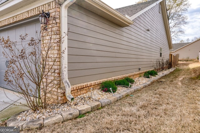 view of side of home with an attached garage