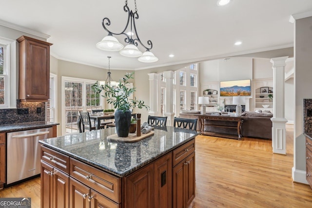 kitchen with crown molding, light wood-type flooring, decorative columns, a notable chandelier, and stainless steel dishwasher