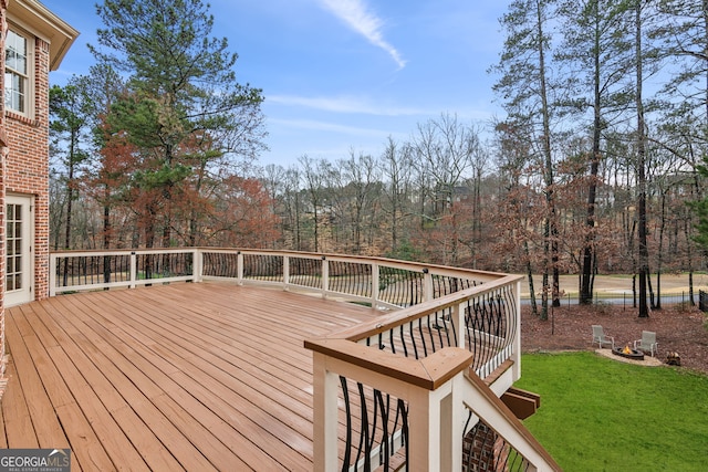 wooden deck featuring a yard