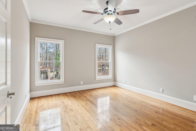 unfurnished room with crown molding, wood finished floors, baseboards, and ceiling fan