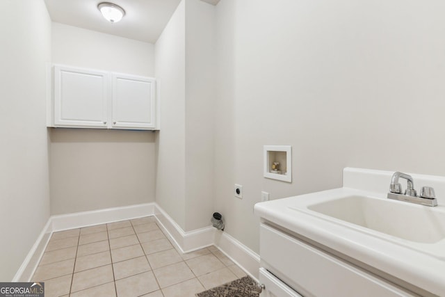 clothes washing area with light tile patterned floors, cabinet space, a sink, washer hookup, and electric dryer hookup