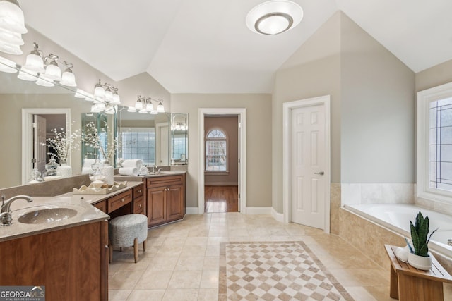 full bathroom with tile patterned floors, vaulted ceiling, and a sink