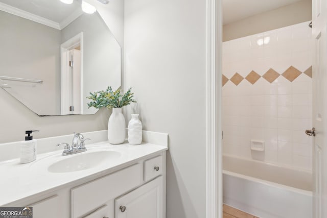 bathroom featuring shower / bathing tub combination, ornamental molding, and vanity