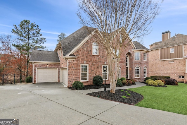 view of front of property featuring a front lawn, fence, concrete driveway, a garage, and brick siding