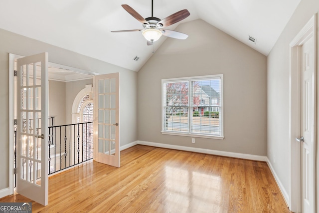 spare room featuring wood finished floors, visible vents, french doors, and baseboards