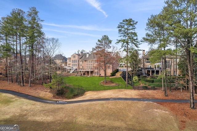 view of community featuring stairs and a yard