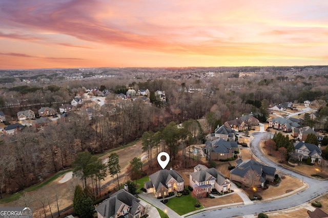 aerial view at dusk featuring a residential view