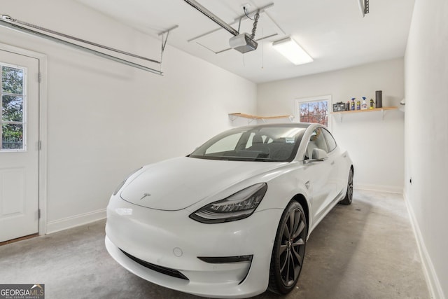 garage featuring a garage door opener and baseboards