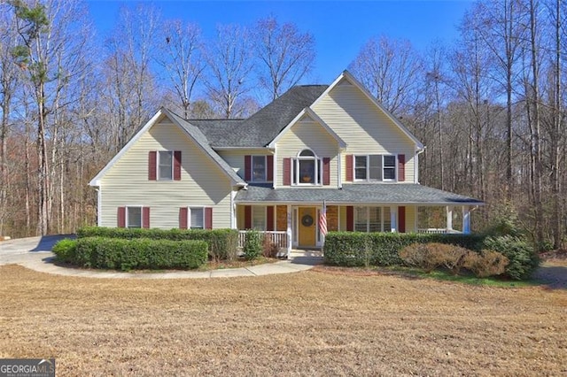 view of front of property with covered porch and a front lawn