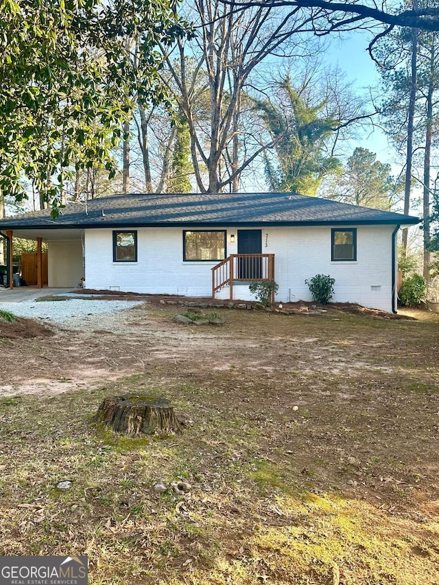 view of front of house with an attached carport and concrete block siding