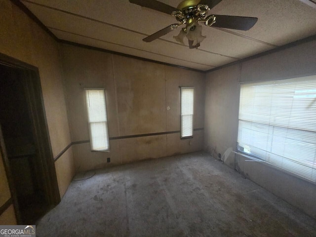 carpeted spare room with lofted ceiling