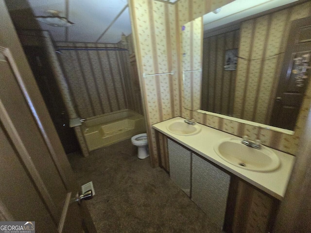 full bathroom with toilet, double vanity, walk in shower, and a sink