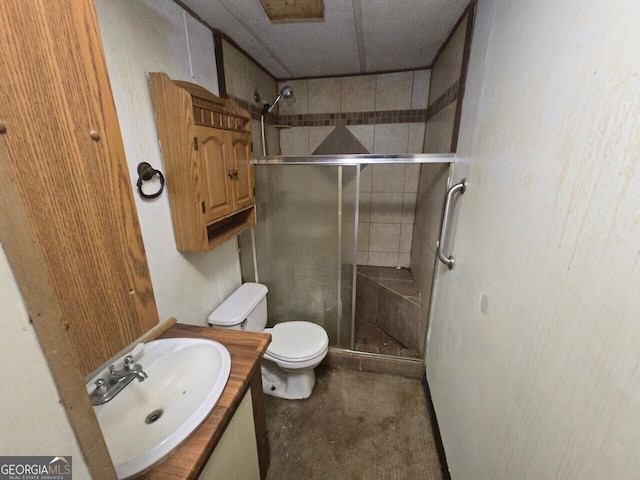 full bath with a stall shower, vanity, and toilet