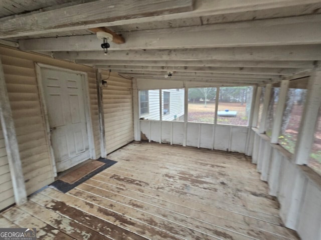 interior space with light wood-style flooring, log walls, and beam ceiling