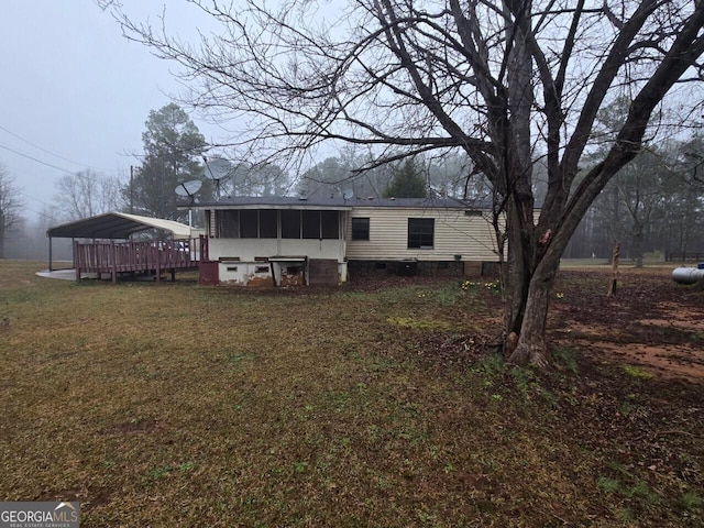 exterior space featuring a yard and a sunroom