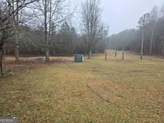 view of yard with a view of trees