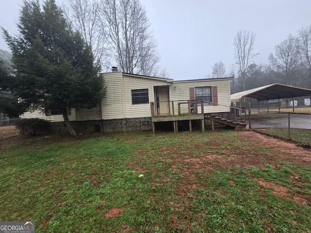 view of front of home featuring a deck, fence, a carport, a front lawn, and a chimney