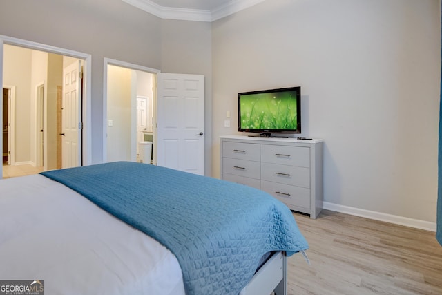 bedroom with light wood-style floors, baseboards, and ornamental molding