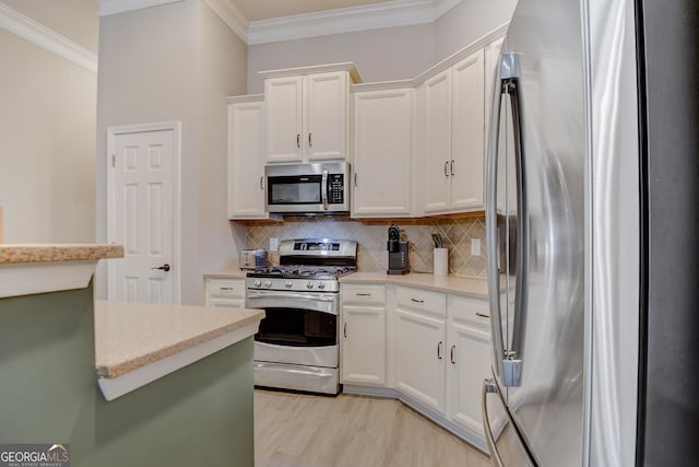 1910 Cedar Glenn Unit 4401, Atlanta, GA 30339 - kitchen with stainless steel appliances, ornamental molding, white cabinetry, decorative backsplash, and light wood finished floors