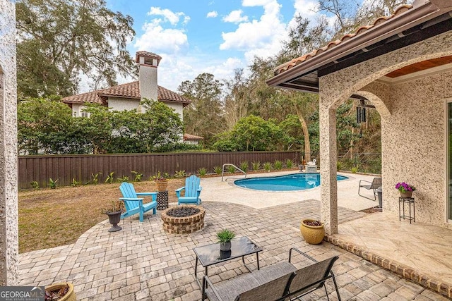 view of pool with a patio, an outdoor fire pit, a fenced backyard, and a fenced in pool