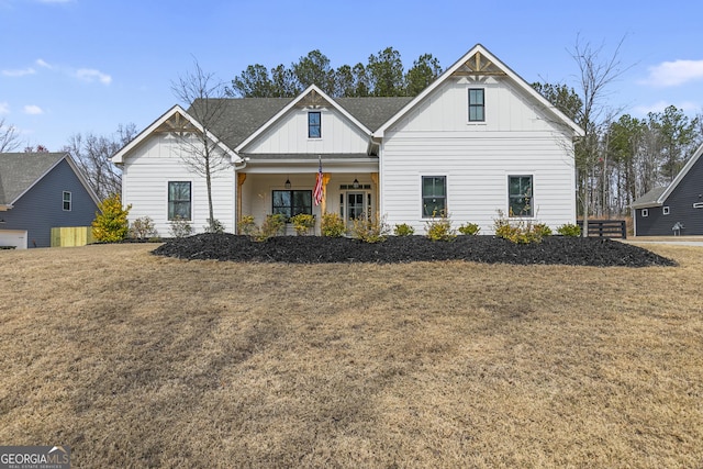 modern farmhouse with covered porch, board and batten siding, and a front lawn