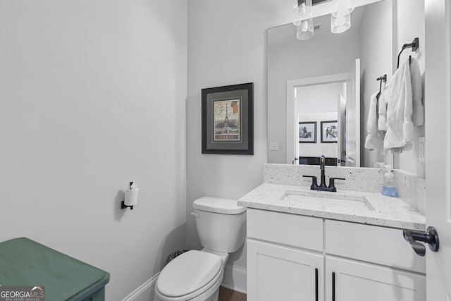 bathroom with toilet and vanity