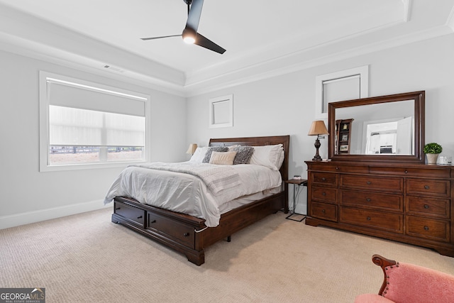 bedroom featuring visible vents, light carpet, a ceiling fan, baseboards, and a raised ceiling