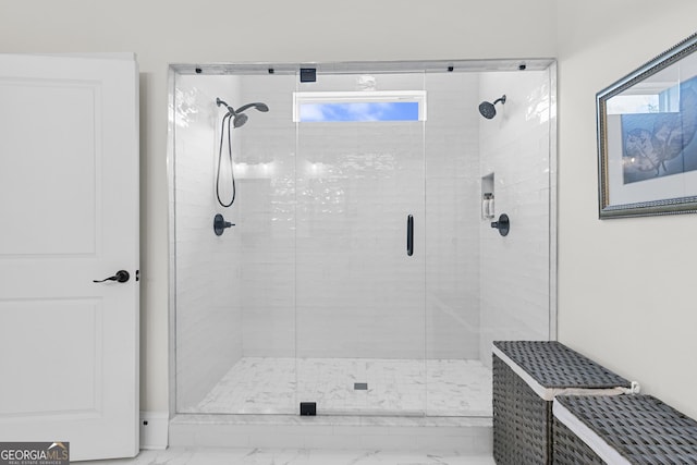 full bathroom with marble finish floor and a stall shower