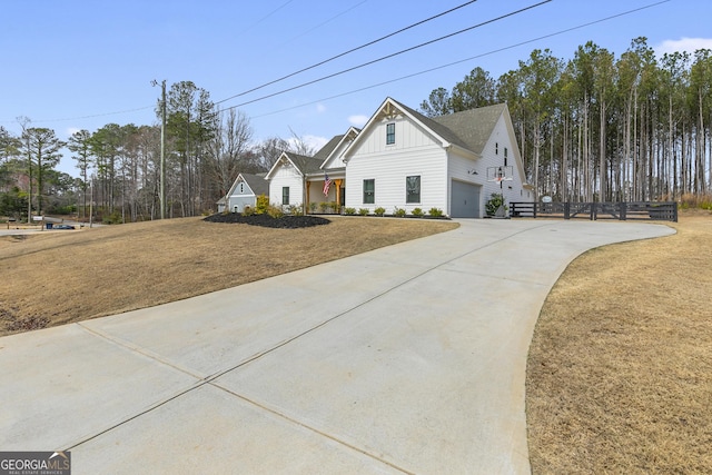 view of front facade featuring a garage, board and batten siding, and driveway