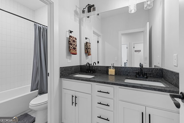 bathroom featuring a sink, toilet, shower / bath combo, and double vanity