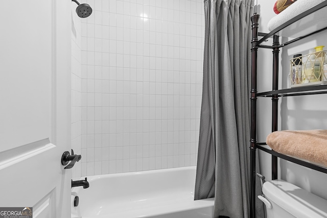 bathroom with shower / bath combination with curtain and toilet