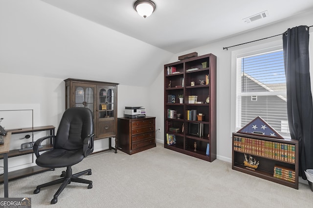 carpeted home office featuring visible vents, baseboards, and vaulted ceiling