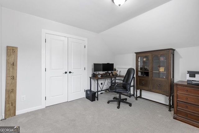 office area featuring baseboards, lofted ceiling, and carpet floors