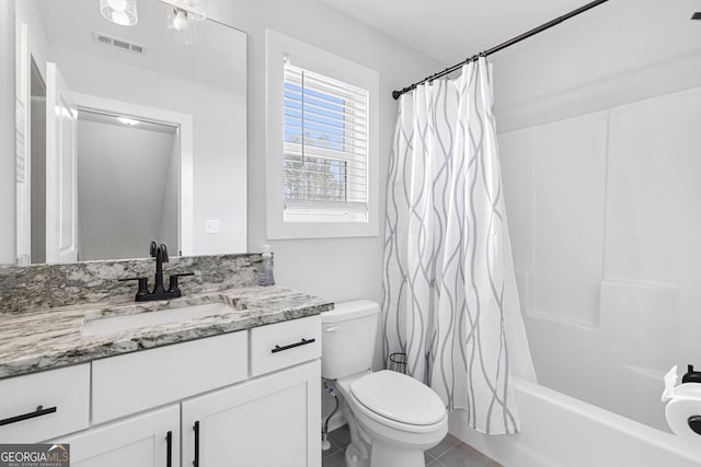 bathroom with vanity, shower / tub combo, toilet, and visible vents