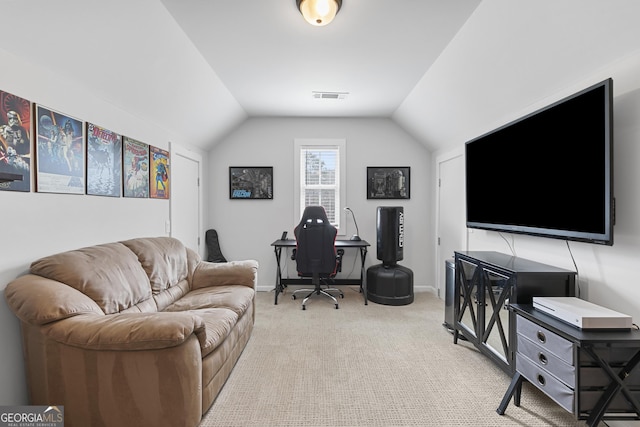 office featuring vaulted ceiling, light colored carpet, visible vents, and baseboards