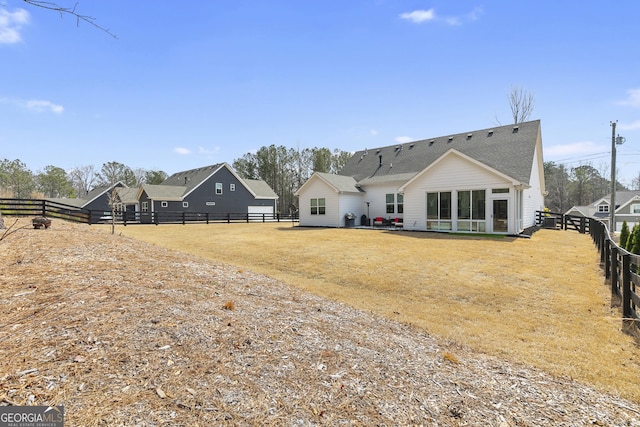 rear view of property with fence