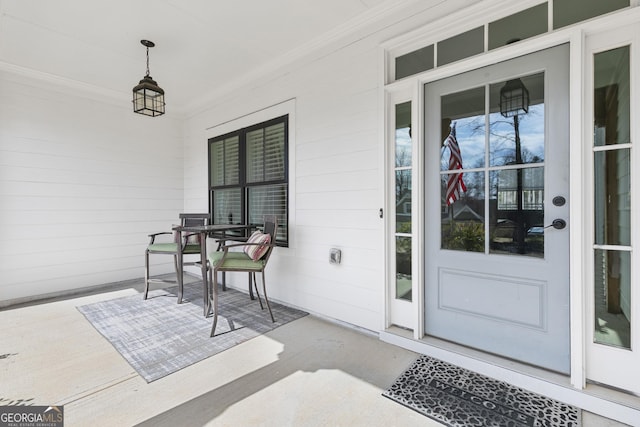 view of exterior entry featuring covered porch