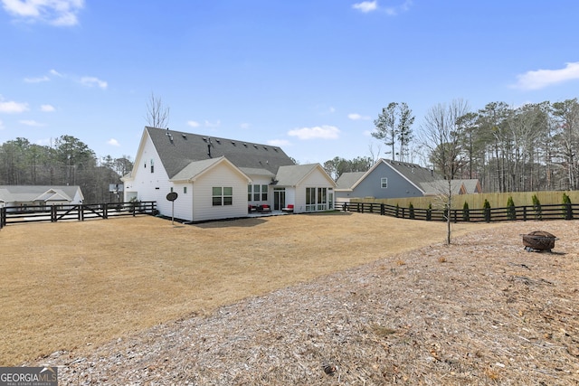 rear view of house with fence