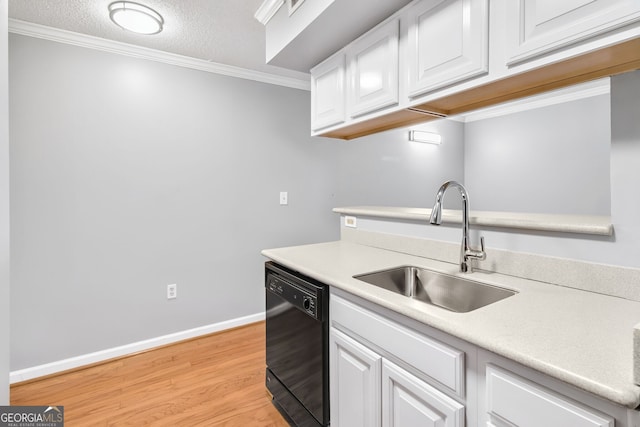 kitchen featuring light wood-style flooring, a sink, white cabinetry, light countertops, and dishwasher