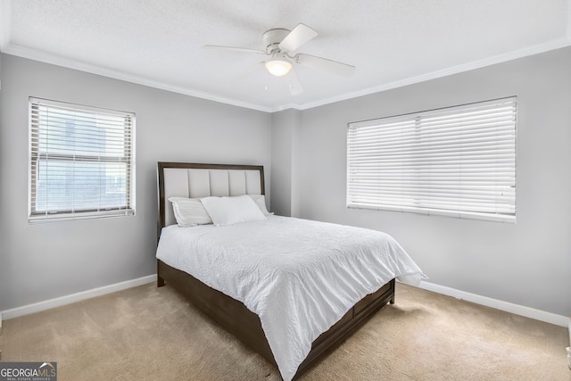 bedroom featuring ornamental molding, carpet, baseboards, and a ceiling fan