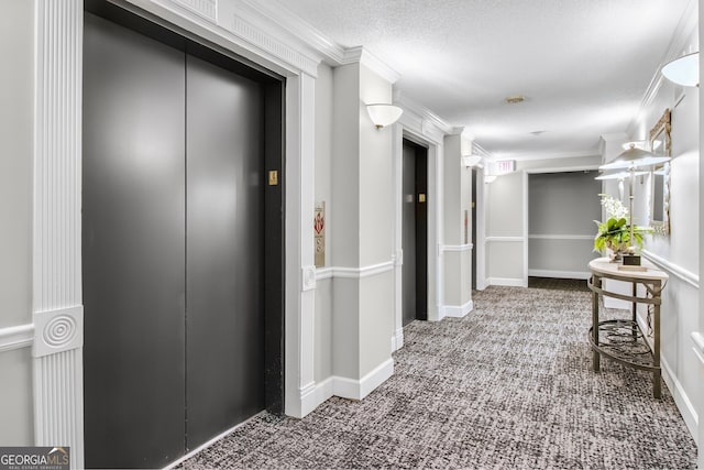 hallway with carpet, ornamental molding, elevator, a textured ceiling, and baseboards