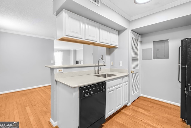 kitchen featuring ornamental molding, light wood-style floors, white cabinets, a sink, and black appliances