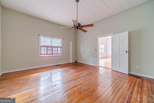 unfurnished room with light wood-type flooring, ceiling fan, and visible vents