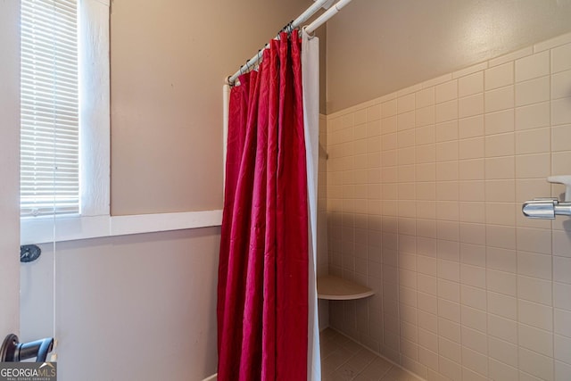 bathroom with tiled shower