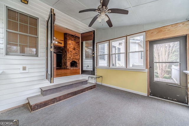 unfurnished sunroom featuring vaulted ceiling and a ceiling fan