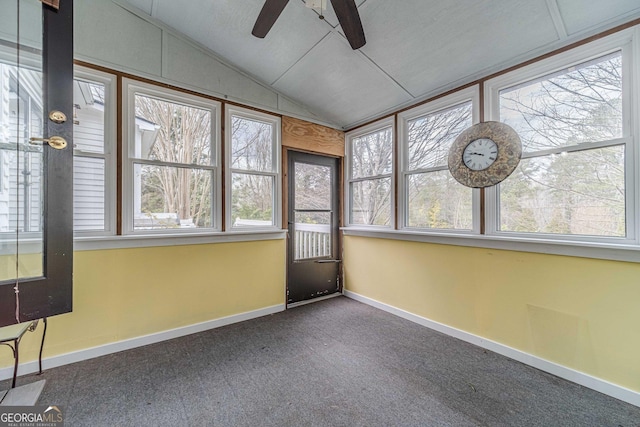 unfurnished sunroom featuring ceiling fan and vaulted ceiling