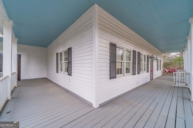 wooden terrace with a porch