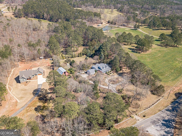 drone / aerial view featuring a forest view